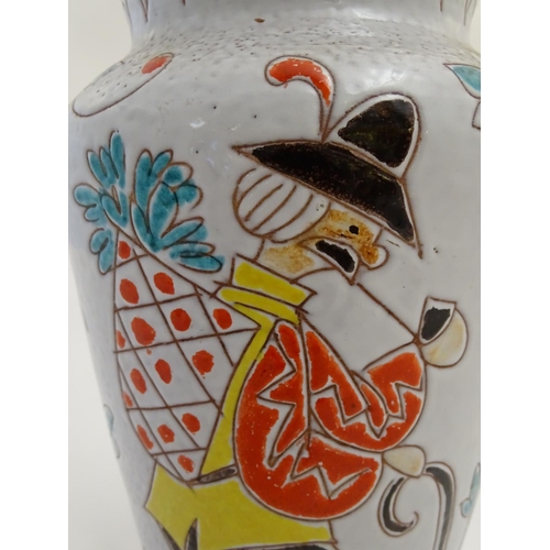 73 - An Italian pottery vase with incised and hand painted naive decoration depicting a hiking figure wit... 