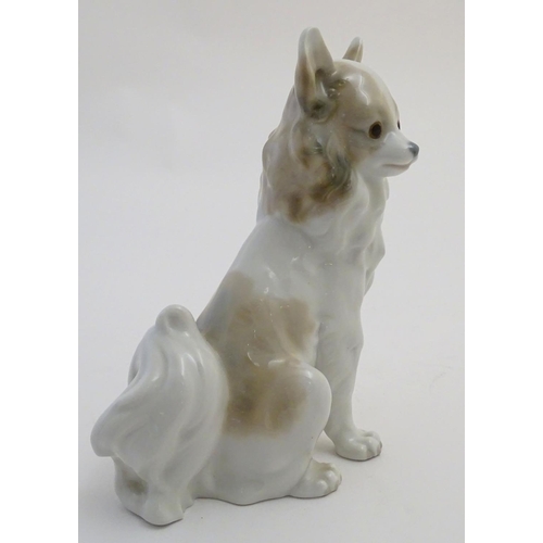 74 - A Nao figurine modelled as a seated long haired chihuahua / papillon dog. Impressed NAO mark to base... 