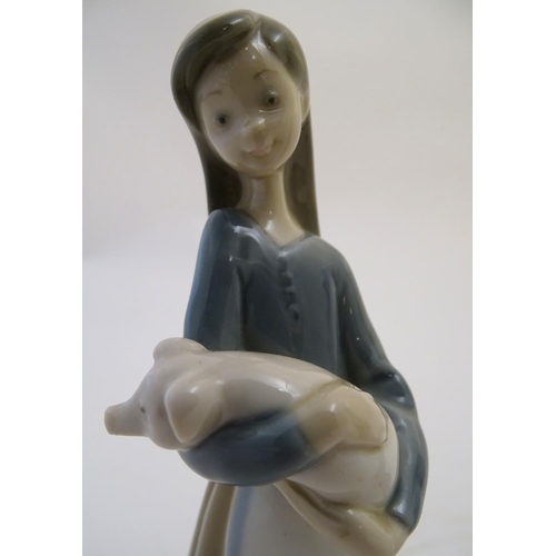 76 - Two Lladro figures to include a girl holding a piglet Girl with Pig, model no. 1011, and Girl with B... 