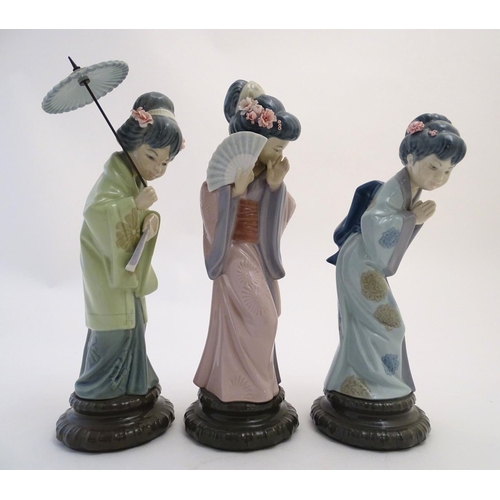 77 - Three Lladro figures modelled as Japanese geisha girls, Oriental Spring, a girl holding a parasol, m... 