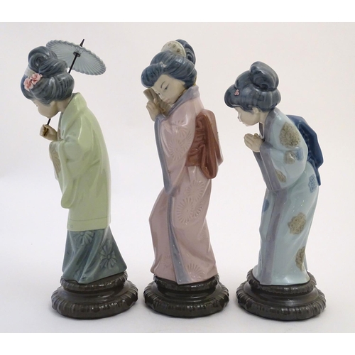 77 - Three Lladro figures modelled as Japanese geisha girls, Oriental Spring, a girl holding a parasol, m... 