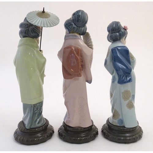 77 - Three Lladro figures modelled as Japanese geisha girls, Oriental Spring, a girl holding a parasol, m... 