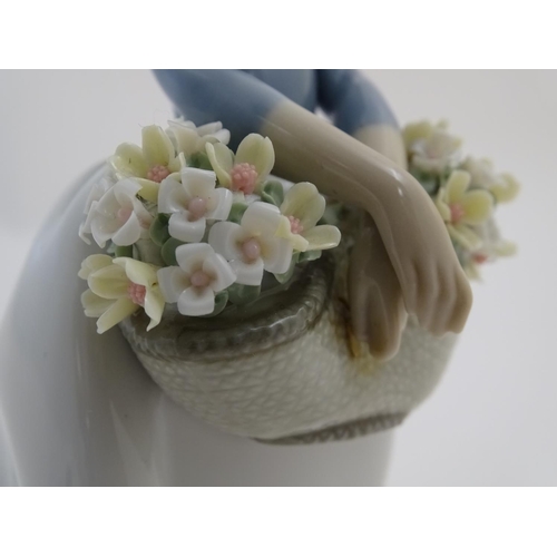 80 - A Lladro figure of a girl with a basket of flowers, May Flowers Girl, model no. 5467. Marked under. ... 