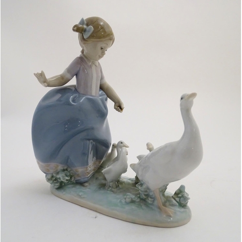 81 - A Lladro figure of a girl with ducks, Hurry Now, model no. 5503. Marked under. Approx. 7