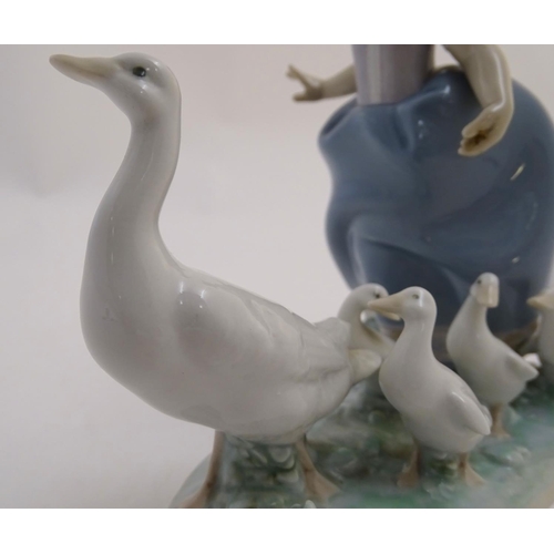 81 - A Lladro figure of a girl with ducks, Hurry Now, model no. 5503. Marked under. Approx. 7