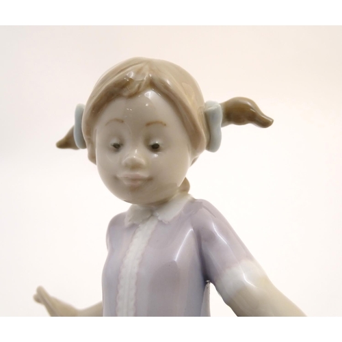 81 - A Lladro figure of a girl with ducks, Hurry Now, model no. 5503. Marked under. Approx. 7