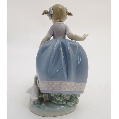 81 - A Lladro figure of a girl with ducks, Hurry Now, model no. 5503. Marked under. Approx. 7