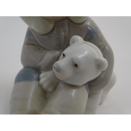 82 - A Lladro figure of an Eskimo girl with a polar bear, model no. 1195. Marked under. Approx. 4 3/4