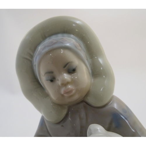 82 - A Lladro figure of an Eskimo girl with a polar bear, model no. 1195. Marked under. Approx. 4 3/4