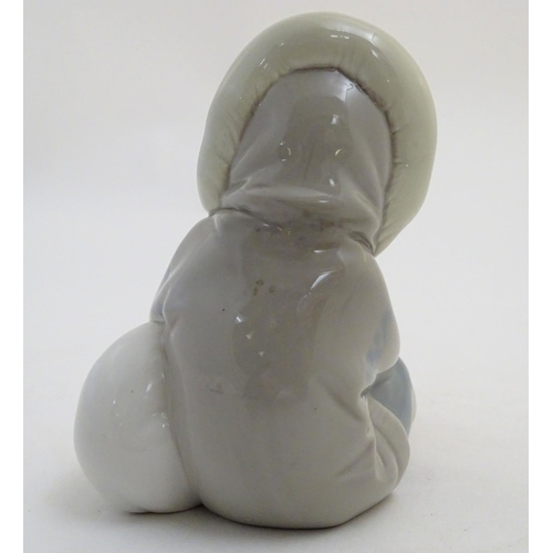 82 - A Lladro figure of an Eskimo girl with a polar bear, model no. 1195. Marked under. Approx. 4 3/4