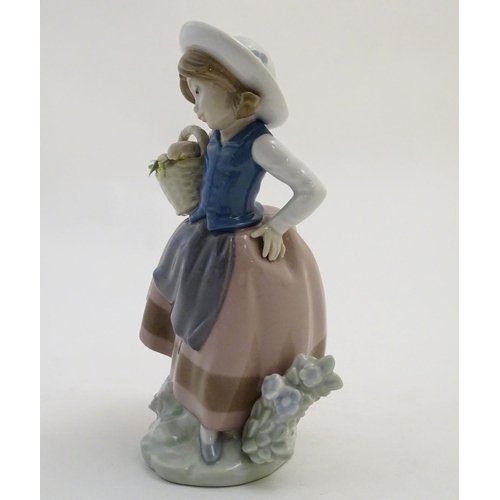 84 - A Lladro figure of a girl holding a basket of flowers, Sweet Scent, model no. 5221. Marked under. Ap... 