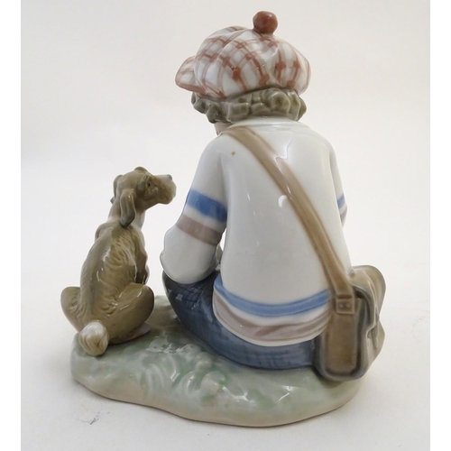 85 - A Lladro figure of a boy with a dog pulling flower petals, I Hope She Does, model no. 5450. Marked u... 