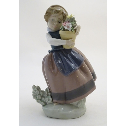 86 - A Lladro figure of a girl with a flower pot, Spring is Here, model no. 5223. Approx. 7