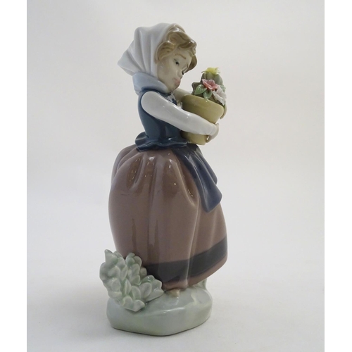 86 - A Lladro figure of a girl with a flower pot, Spring is Here, model no. 5223. Approx. 7