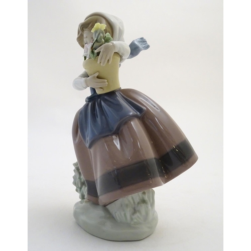 86 - A Lladro figure of a girl with a flower pot, Spring is Here, model no. 5223. Approx. 7