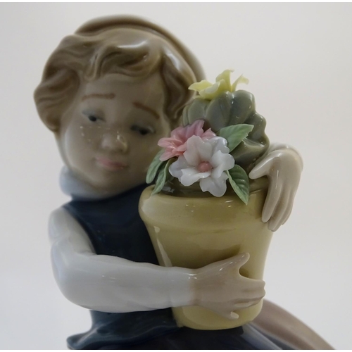 86 - A Lladro figure of a girl with a flower pot, Spring is Here, model no. 5223. Approx. 7