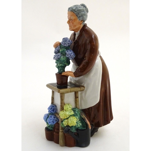 94 - A Royal Doulton figurine depicting an old woman with flowers, Flora, model number 2349. Marked under... 