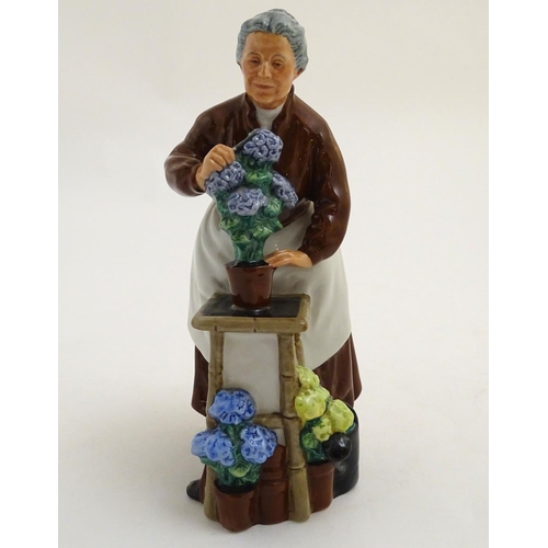 94 - A Royal Doulton figurine depicting an old woman with flowers, Flora, model number 2349. Marked under... 