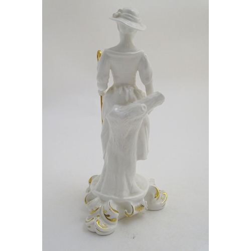 97 - A Royal Crown Derby white glazed female figure modelled as a shepherdess, with a crook and holding l... 