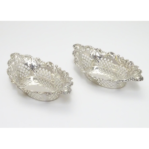 198 - A pair of silver plate bon bon dishes with pierced decoration. Approx. 6” long.