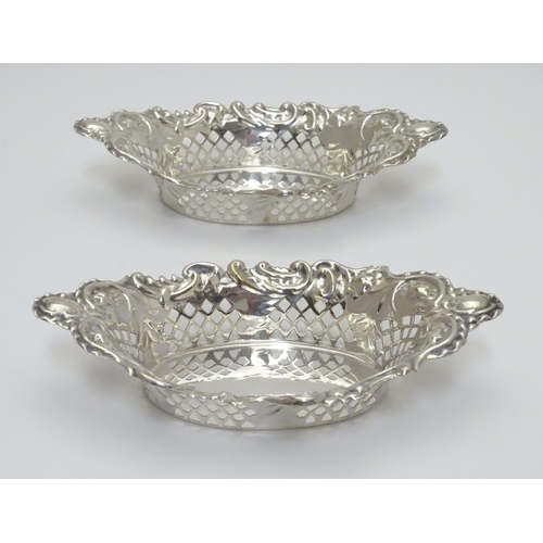 198 - A pair of silver plate bon bon dishes with pierced decoration. Approx. 6” long.