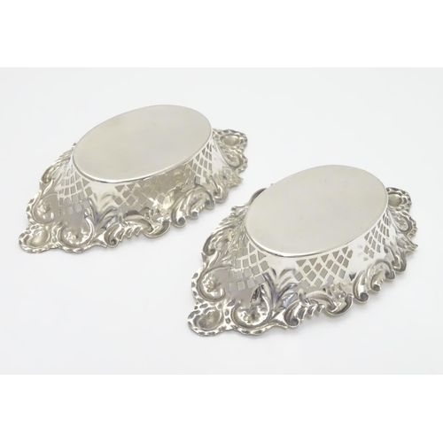 198 - A pair of silver plate bon bon dishes with pierced decoration. Approx. 6” long.