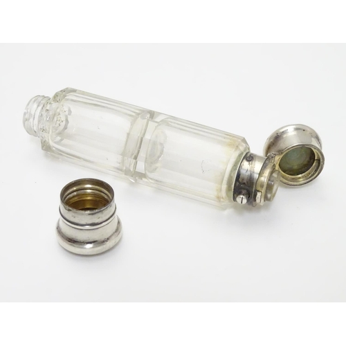 215 - A 19thC double ended scent bottle / flask the class body with with  white metal ends and yellow meta... 