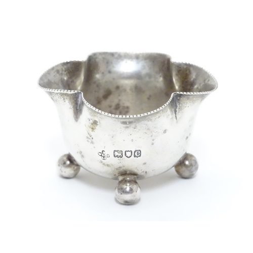 219 - A Victorian silver salt of quatrefoil shape raised on four spherical feet. Hallmarked London 1898 ma... 