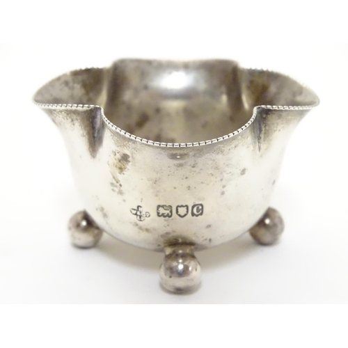 219 - A Victorian silver salt of quatrefoil shape raised on four spherical feet. Hallmarked London 1898 ma... 