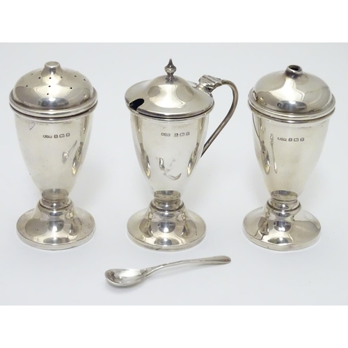 237 - An Art Deco silver three piece cruet set comprising salt, pepper and mustard pot (with spoon and fac... 