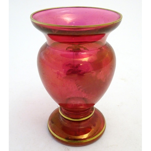 152 - An early 20thC Mary Gregory cranberry glass vase, decorated with an enamelled vignette of girl in wo... 