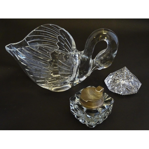 154 - An assortment of glass items, comprising a table formed as a preening swan, three art glass paperwei... 