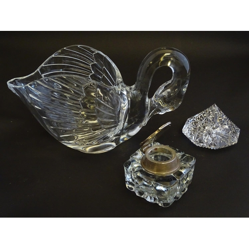 154 - An assortment of glass items, comprising a table formed as a preening swan, three art glass paperwei... 