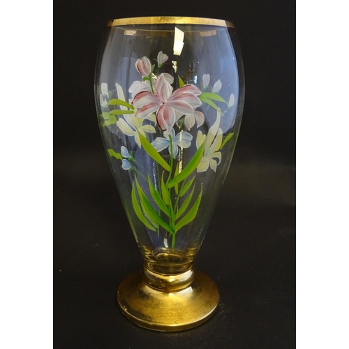 168 - An early 20thC clear glass vase, with gilt base and rim, decorated with polychrome enamelled lilies.... 