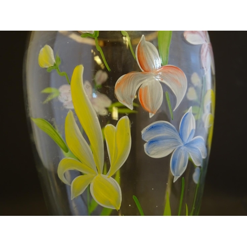 168 - An early 20thC clear glass vase, with gilt base and rim, decorated with polychrome enamelled lilies.... 