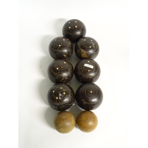 97 - Seven early 20thC lignum vitae bowls, each approximately 4 1/2'' in diameter. Together with two hard... 