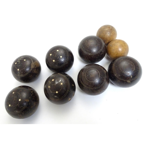 97 - Seven early 20thC lignum vitae bowls, each approximately 4 1/2'' in diameter. Together with two hard... 