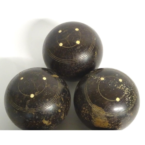 97 - Seven early 20thC lignum vitae bowls, each approximately 4 1/2'' in diameter. Together with two hard... 