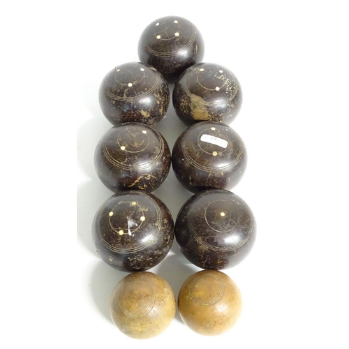 97 - Seven early 20thC lignum vitae bowls, each approximately 4 1/2'' in diameter. Together with two hard... 