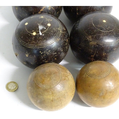 97 - Seven early 20thC lignum vitae bowls, each approximately 4 1/2'' in diameter. Together with two hard... 