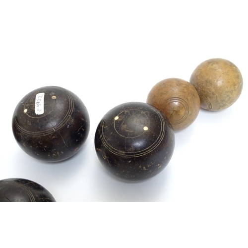 97 - Seven early 20thC lignum vitae bowls, each approximately 4 1/2'' in diameter. Together with two hard... 