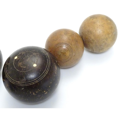 97 - Seven early 20thC lignum vitae bowls, each approximately 4 1/2'' in diameter. Together with two hard... 