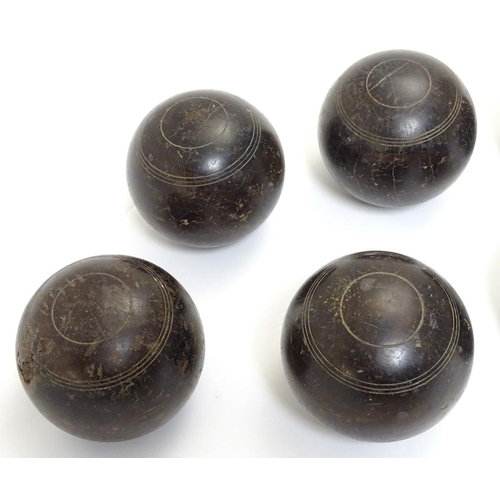 97 - Seven early 20thC lignum vitae bowls, each approximately 4 1/2'' in diameter. Together with two hard... 