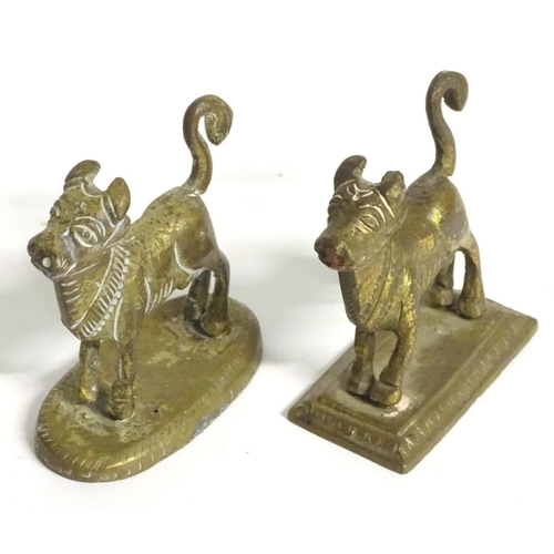 304 - A quantity of assorted brass items, to include two naive folk art cows on bases, two horse brasses a... 