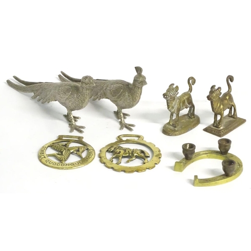 304 - A quantity of assorted brass items, to include two naive folk art cows on bases, two horse brasses a... 