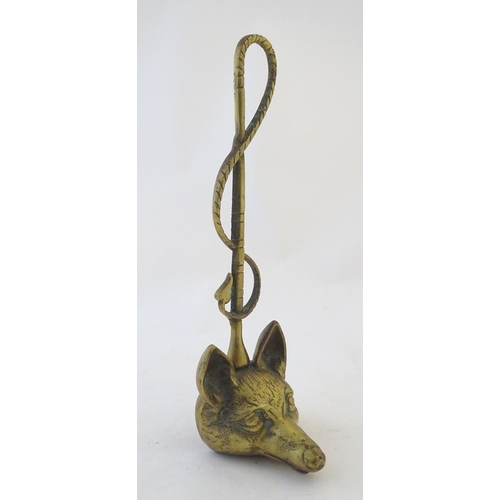 405 - A Victorian cast brass figural doorstop/door porter, hunting themed, formed as a fox mask surmounted... 