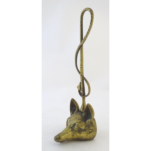 405 - A Victorian cast brass figural doorstop/door porter, hunting themed, formed as a fox mask surmounted... 