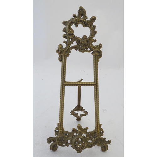 858 - A 20thC cast brass table top easel with scrolling foliate decoration. Approx. 15 1/2