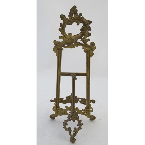 858 - A 20thC cast brass table top easel with scrolling foliate decoration. Approx. 15 1/2