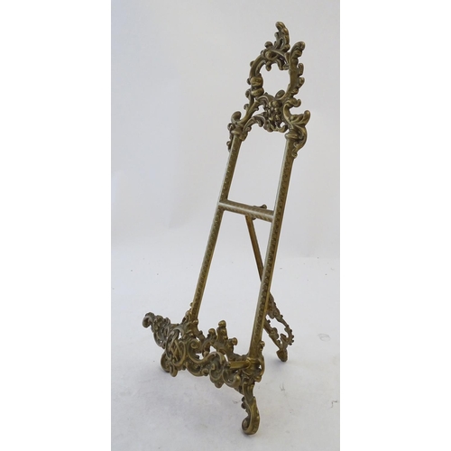 858 - A 20thC cast brass table top easel with scrolling foliate decoration. Approx. 15 1/2